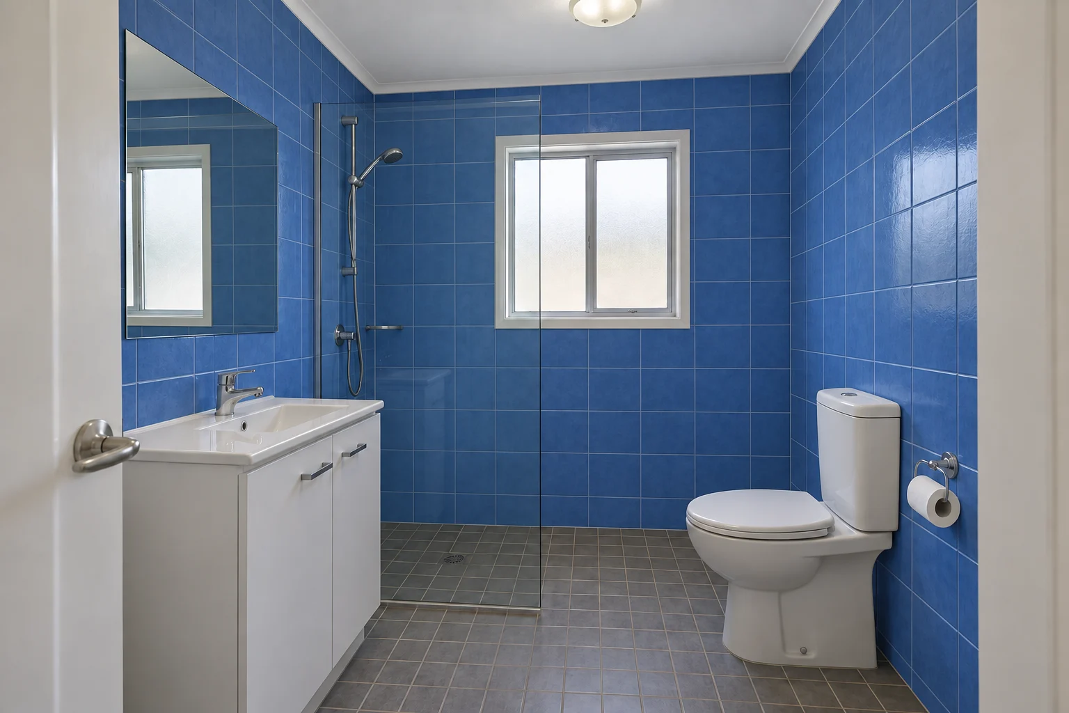 Blue bathroom wall tile with relatively subtle blue-grey joints.